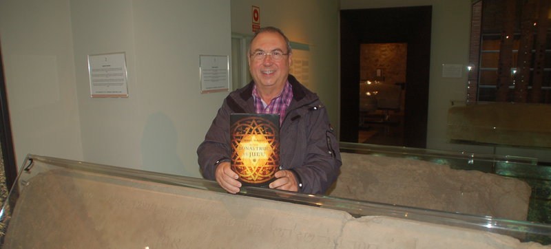 Imatge de Miquel Fañanàs, ahir amb el seu nou llibre, entre les làpides funeràries que es conserven al Museu d'Història dels Jueus.